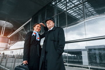 Man with woman. Aircraft crew in work uniform is together outdoors in the airport