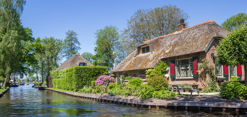 Panorama of an old farmhouse at the canal in Giethoorn, Netherlands