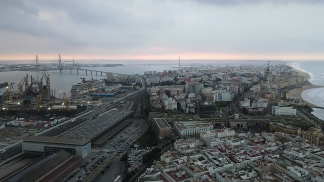 Cinematic aerial footage of Cadiz skyline and the la Pepa bridge.