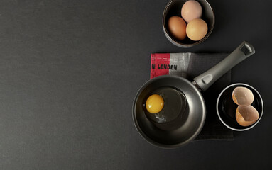 Healthy breakfast eating concept, farm chicken eggs, black background