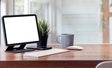 Mockup blank screen tablet on wooden table with copy space.