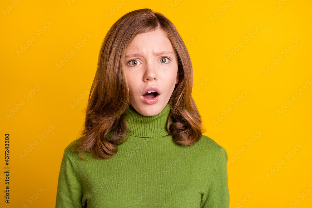 Wall mural photo portrait young girl in green turtleneck shocked with opened mouth isolated vivid green color b