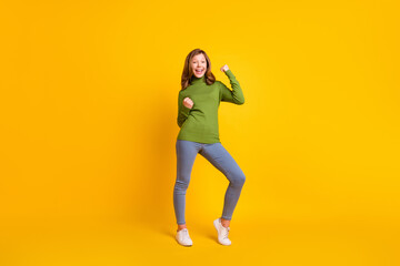 Fototapeta na wymiar Full length body size photo smiling girl in casual clothes gesturing like winner isolated vivid yellow color background