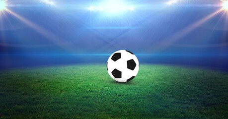 Naklejka premium Composition of football on football pitch with spotlights in sports stadium