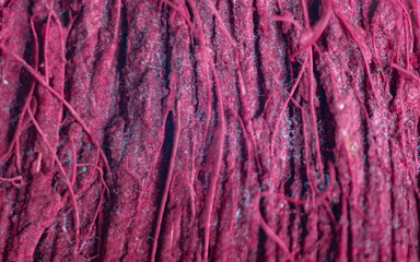 macro photo of wood painted in pink, aromatic sliver
