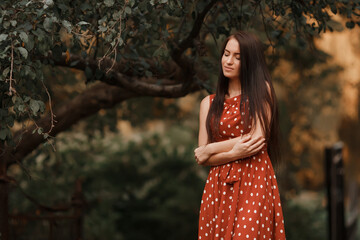 Young girl in retro dress posing in nature.