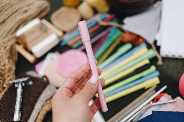 Female hand holding pink recycled plastic pen. Writing pen made from recycled materials.