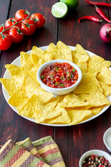 Corn chips nachos with salsa dip. Mexican food. Vegetarian food.