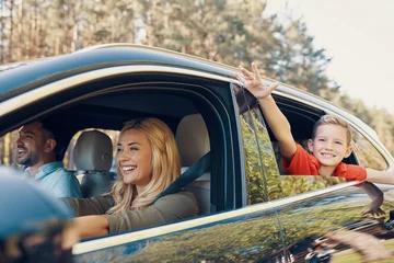 Foto op Canvas Young beautiful family with little boy having fun and smiling while driving in the car © gstockstudio