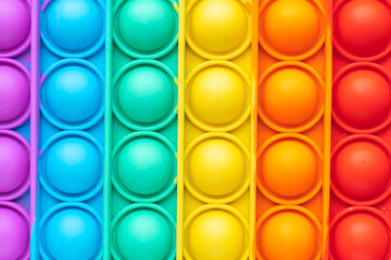 Close-up of a pop-it toy. Colorful background and copy space.