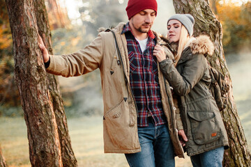 Hiking couple with backpack walking in the forest and exploring outdoors. Freedom and active travel concept.