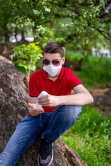 A teenage boy in a medical mask