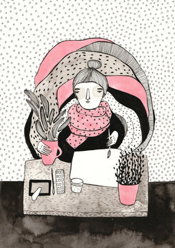 An artist working with a hot tea and a pile of blankets