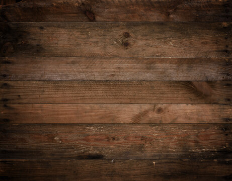 Dark wood texture. Weathered vignetted rustic wood background from aged old planks with nails.