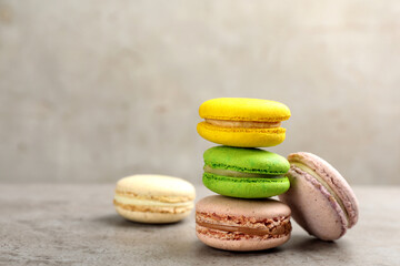 Delicious macarons on grey table. Space for text