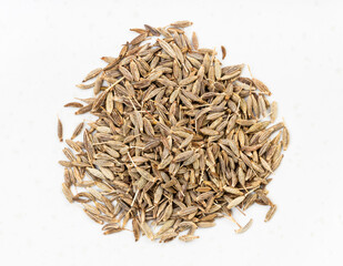 pile of cumin (cuminum cyminum) seeds close up