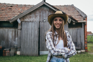 woman rancher standing in front of barn