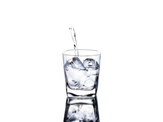 glass of water with ice And pour water into the glass isolated on a white background