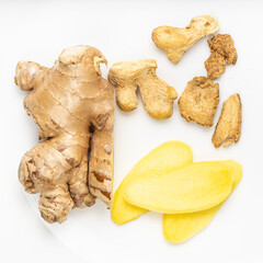 top view of sliced and dried ginger roots on gray