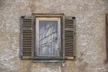 Fototapeta na wymiar Altes Fenster mit Fensterladen an einem Wohnhaus
