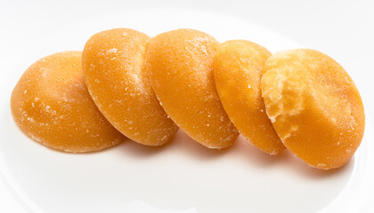 several whole round pieces of palm sugar on gray