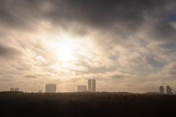 Fototapeta na wymiar smog over city park and urban houses on horizon