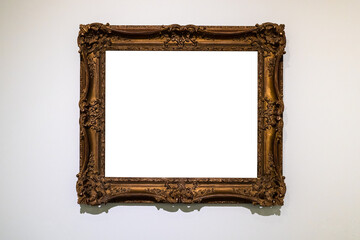 old decorated wide dark picture frame on gray wall