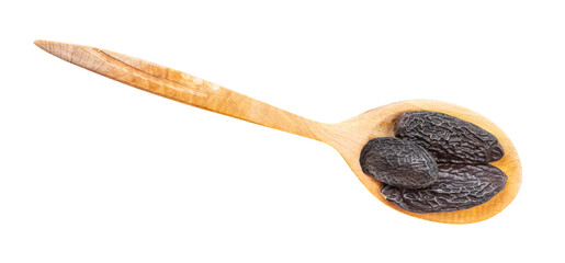 top view of dried tonka beans in spoon isolated