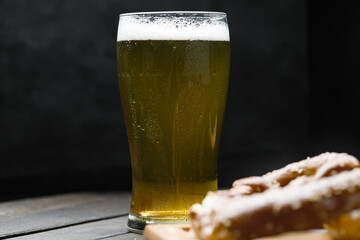 Glass Of Beer On Wooden Board Black Background. Side View. Low Key. Copy Space.