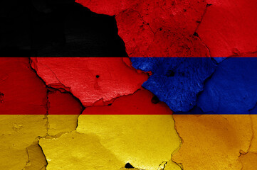 flags of Germany and Armenia painted on cracked wall