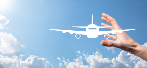 Male hand holding plane airplane icon on blue background. Banner.nline ticket purchase.Travel icons...