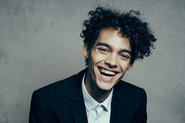 Cheerful man in a suit with curly hair emotions close-up official