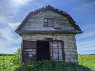 old and broken house made of white bricks on a blue sky background