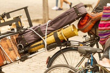 Street musician carrying instruments by bicycle, musical concept.