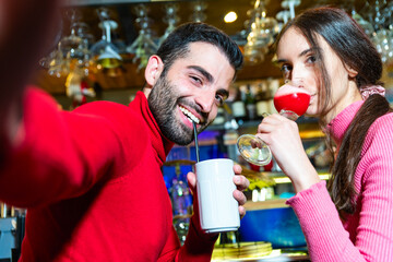 caucasian happy couple taking selfie and having fun with pub