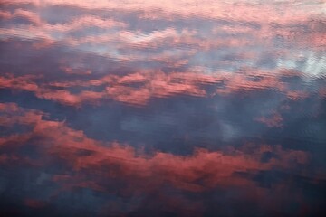 Fototapeta premium High-contrast shadows and bright reflections on the purple and scarlet surface with violet tints close-up. Bright ripples on colorful smooth water surface close up. Abstract backgrounds and textures. 