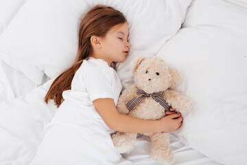 Lovely child sleeping with a teddy bear