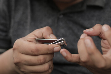 A man cuts his nails