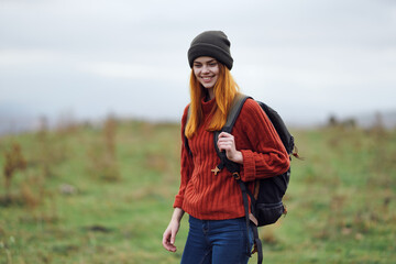 Fototapeta premium cheerful woman hiker in autumn clothes with a cutter in the mountains landscape on a trip