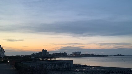 Obraz premium Hingham Shipyard condos in the sunset, Streets lit by streetlights