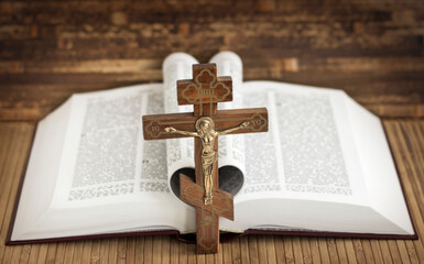 Wooden cross on the background of the Bible. Prayer.