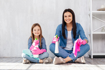 Cheerful family having fun during house cleaning process