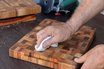 Soak a wooden cutting board with mineral oil using a swab.