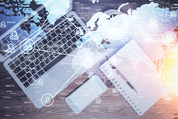 Social network hologram drawings over computer on the desktop background. Top view. Double exposure.