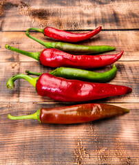 Add heat to dishes. Chili peppers wooden background. Red and green chile peppers. Organic chillies