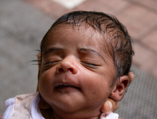 a new borne boy child sleeping on his mother's hand