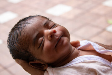 a new borne boy child sleeping on his mother's hand