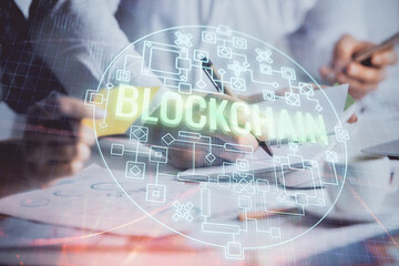 Double exposure of blockchain theme drawing over people taking notes background. Concept of...
