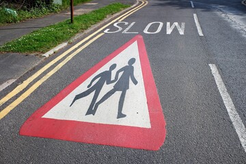 Warning sign on roadway at children school crossing