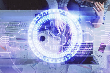 Double exposure of man and woman working together and crypto theme hologram drawing. Computer background. Blockchain concept. Top View.